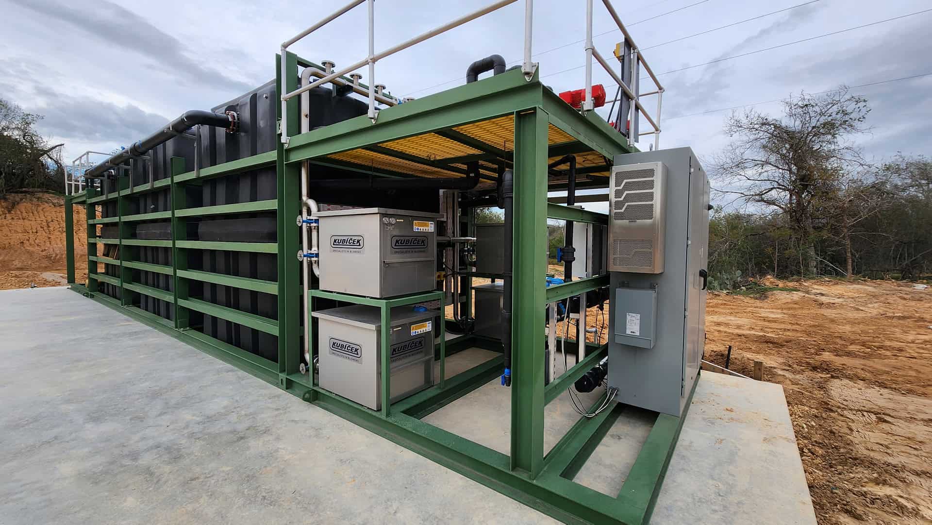 High-efficiency industrial water treatment system on concrete slab at construction site.