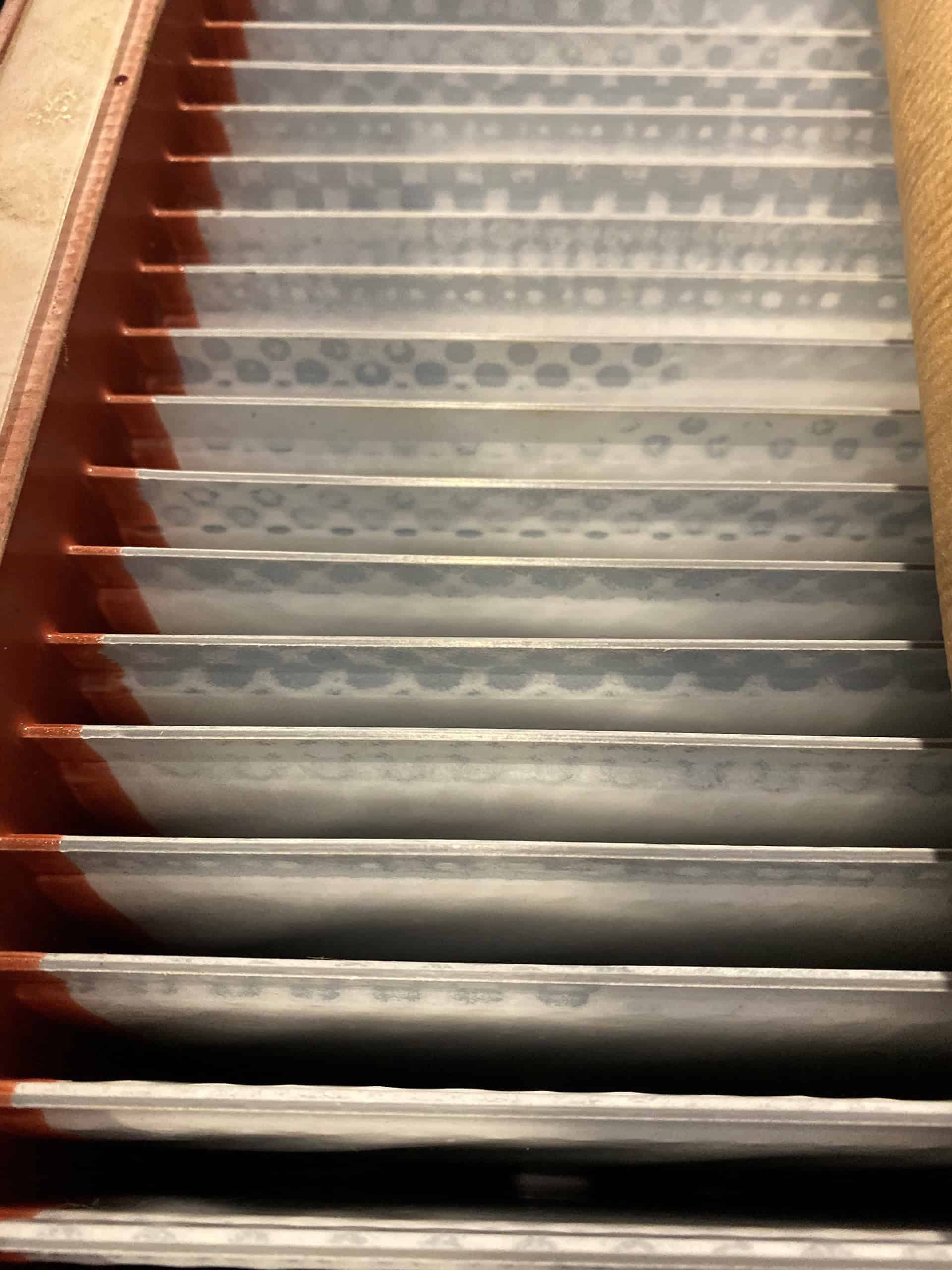 High voltage transformer lamination stacks displaying intricate steel core layers for electrical transformer manufacturing at A3 USA.